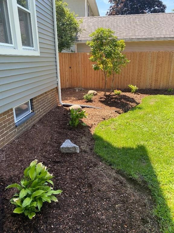 64 Chilson Street Springfield, MA 01118 - Photo 29 of 36 a view of a backyard with grass and a potted plant