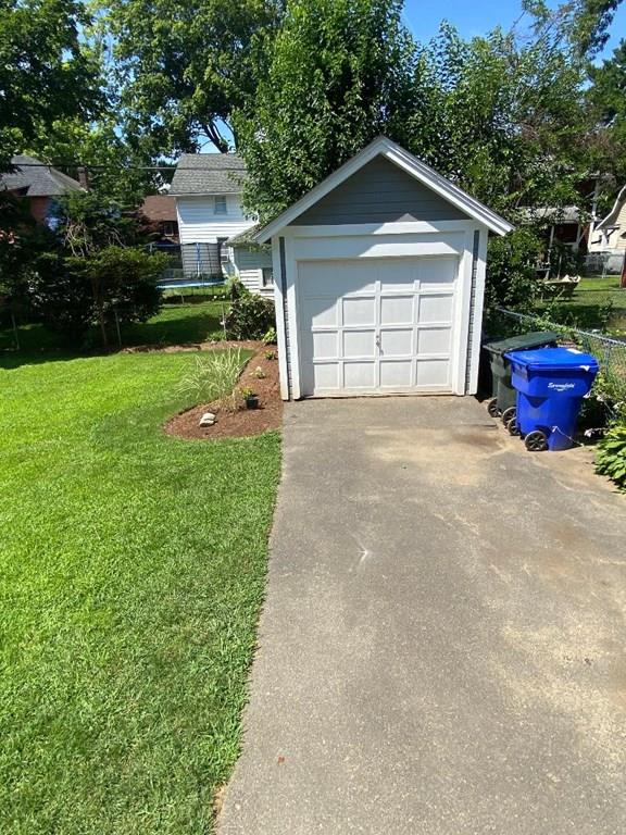 64 Chilson Street Springfield, MA 01118 - Photo 4 of 36 a front view of a house with a yard and garage