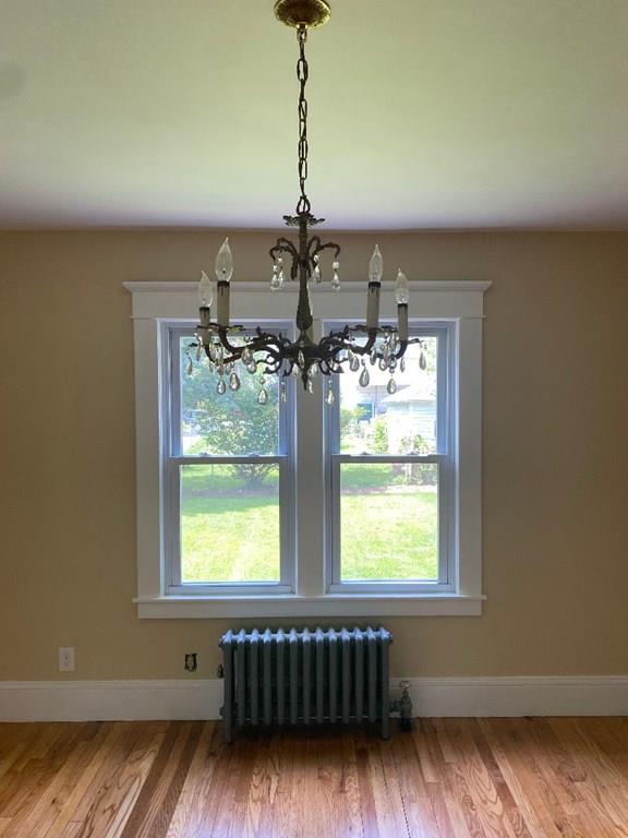 64 Chilson Street Springfield, MA 01118 - Photo 8 of 36 a dining room with wooden floor a chandelier and windows