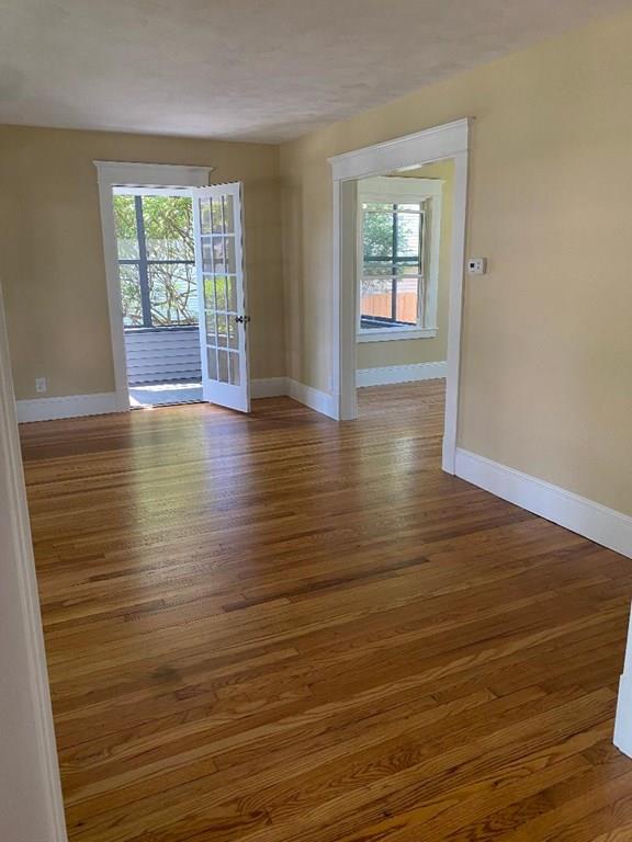 64 Chilson Street Springfield, MA 01118 - Photo 9 of 36 an empty room with wooden floor and windows