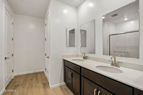 a bathroom with a double vanity sink and a mirror