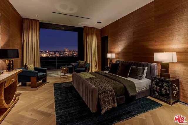 a living room with furniture a rug and a wall painting