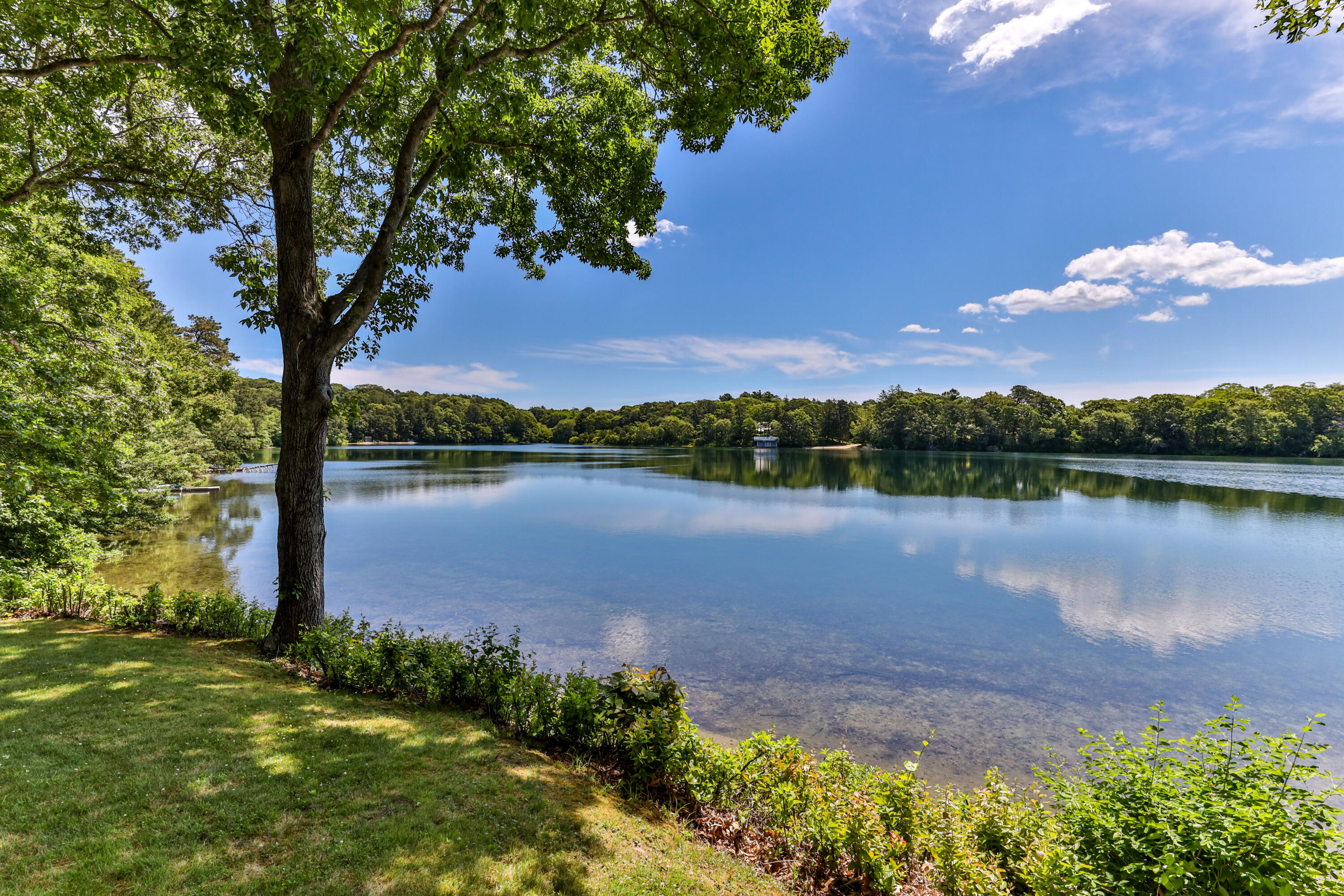 a lake view with a big yard