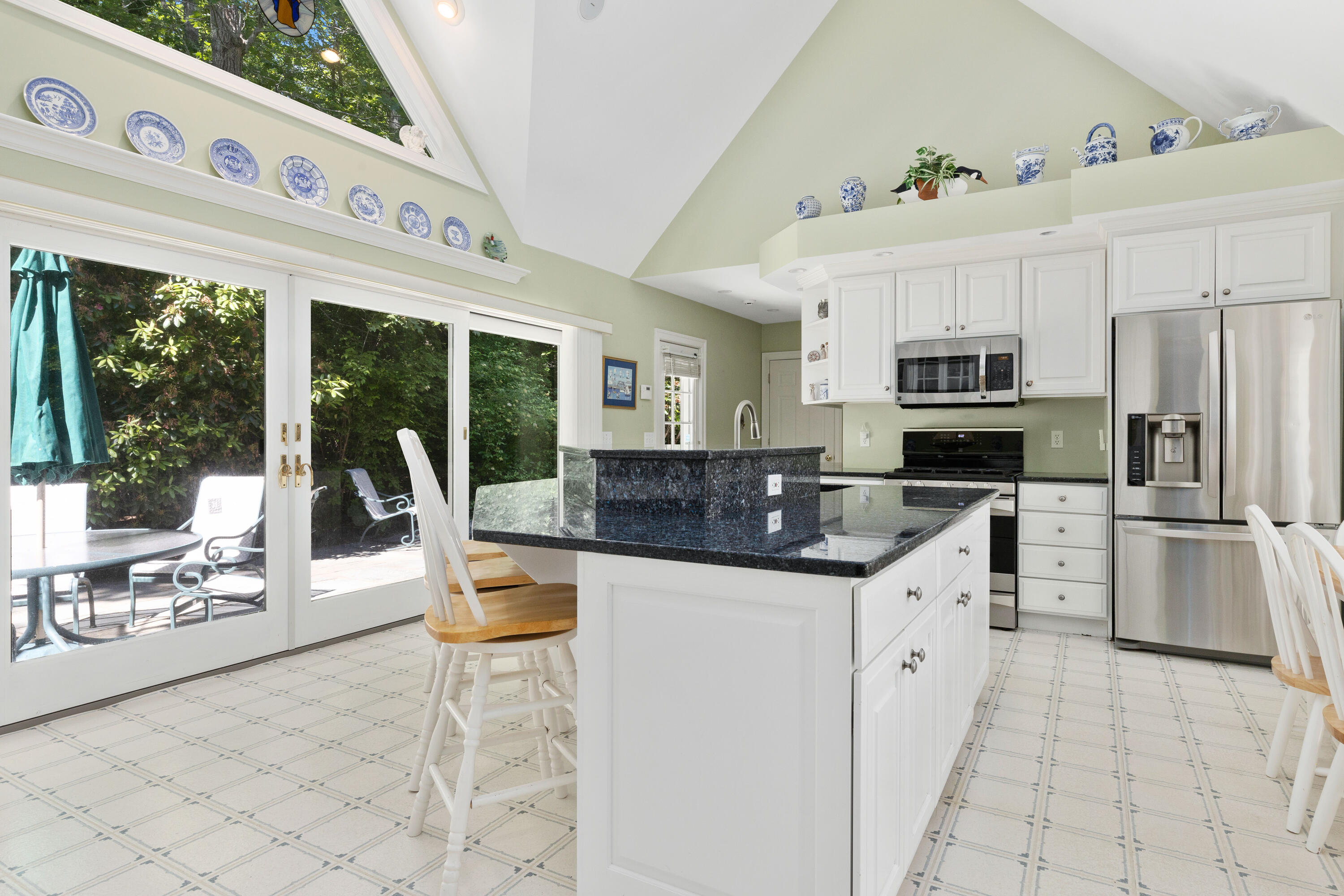 316 Wheeler Road Marstons Mills, MA 02648 - Photo 14 of 50 a kitchen with stainless steel appliances kitchen island granite countertop a sink and cabinets