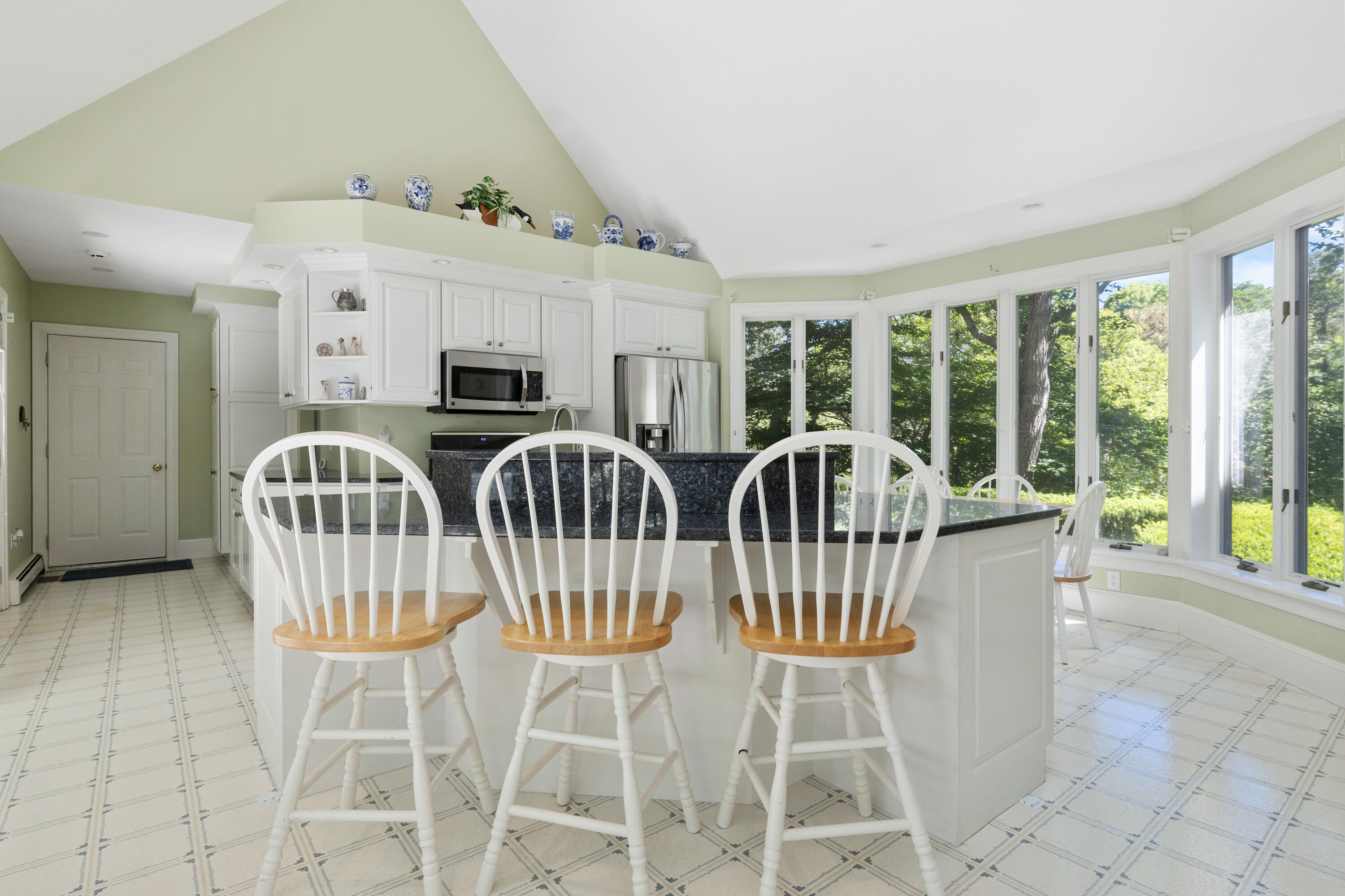 316 Wheeler Road Marstons Mills, MA 02648 - Photo 15 of 50 a view of a dining room with furniture a chandelier and large windows