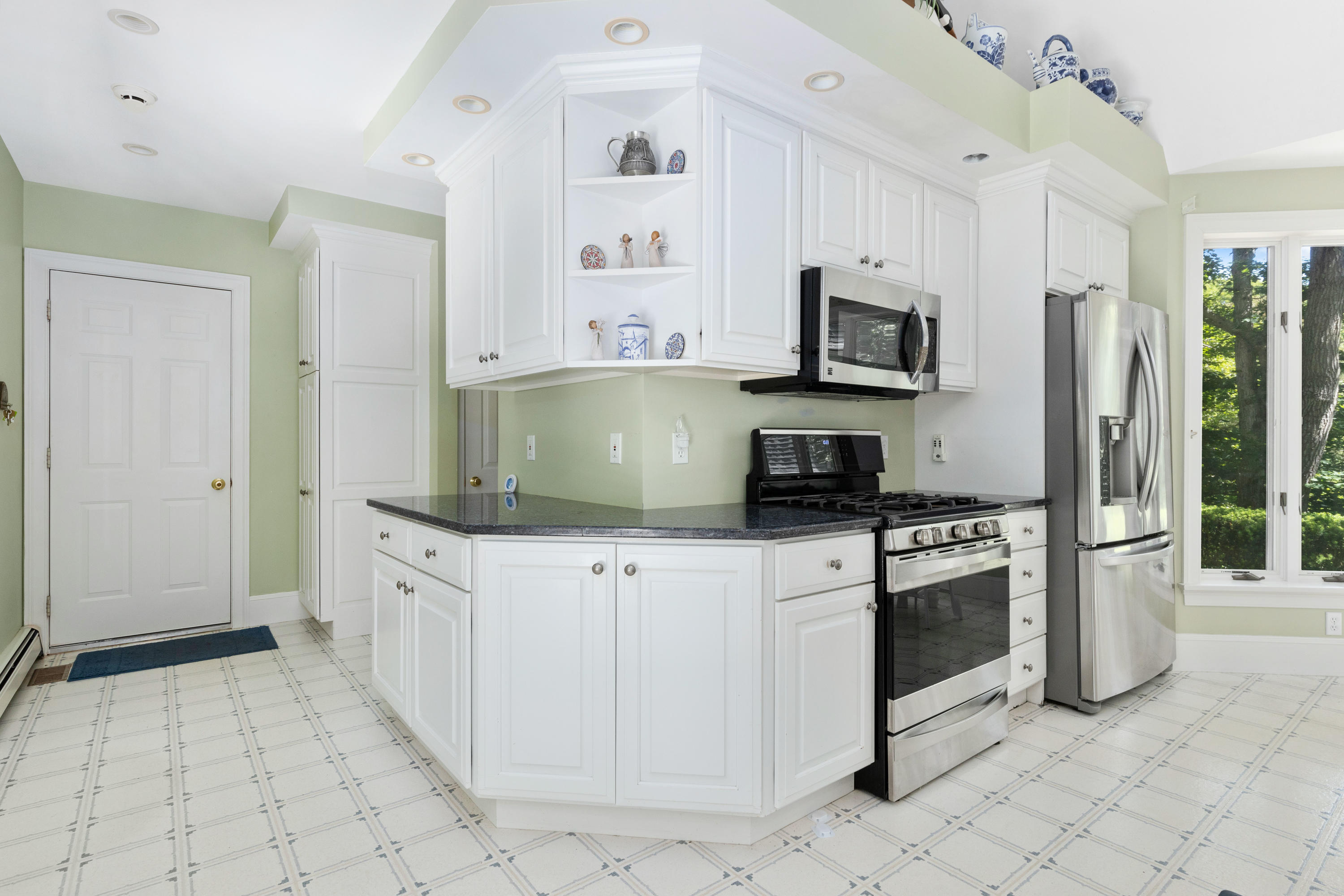 316 Wheeler Road Marstons Mills, MA 02648 - Photo 16 of 50 a kitchen with stainless steel appliances granite countertop a stove a sink and a refrigerator
