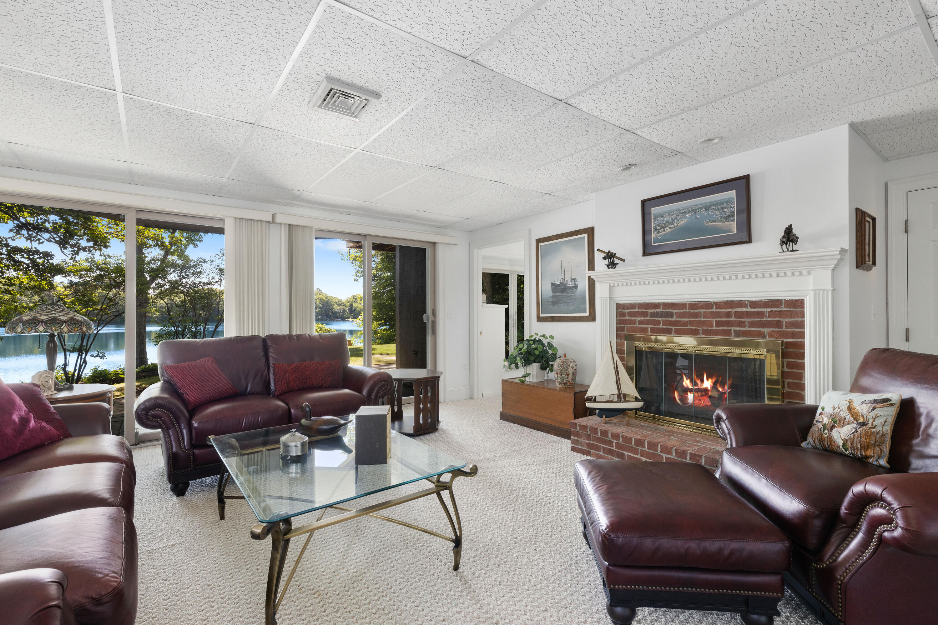 316 Wheeler Road Marstons Mills, MA 02648 - Photo 29 of 50 a living room with furniture fireplace and a large window