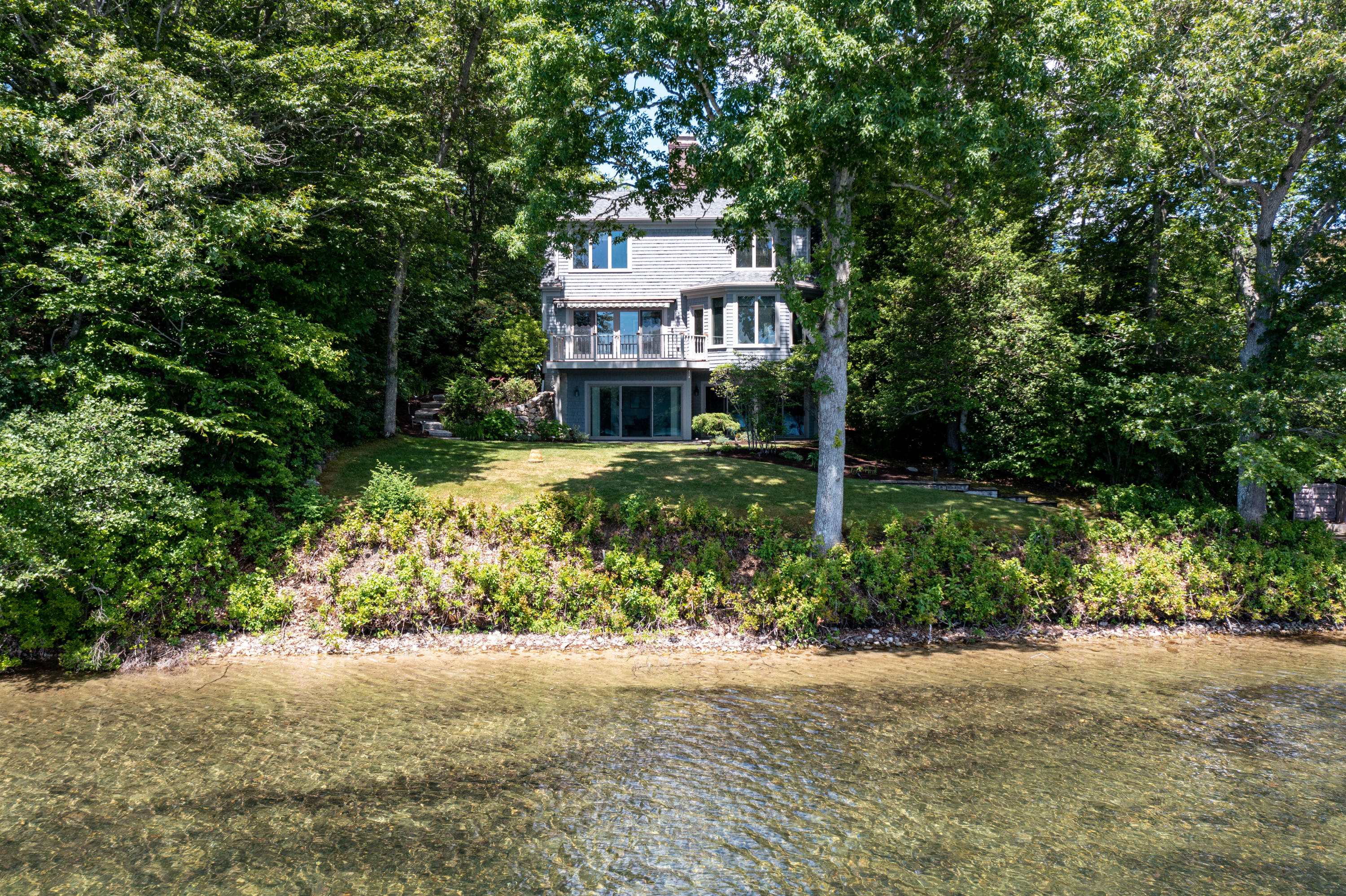 316 Wheeler Road Marstons Mills, MA 02648 - Photo 46 of 50 a front view of a house with a garden and plants