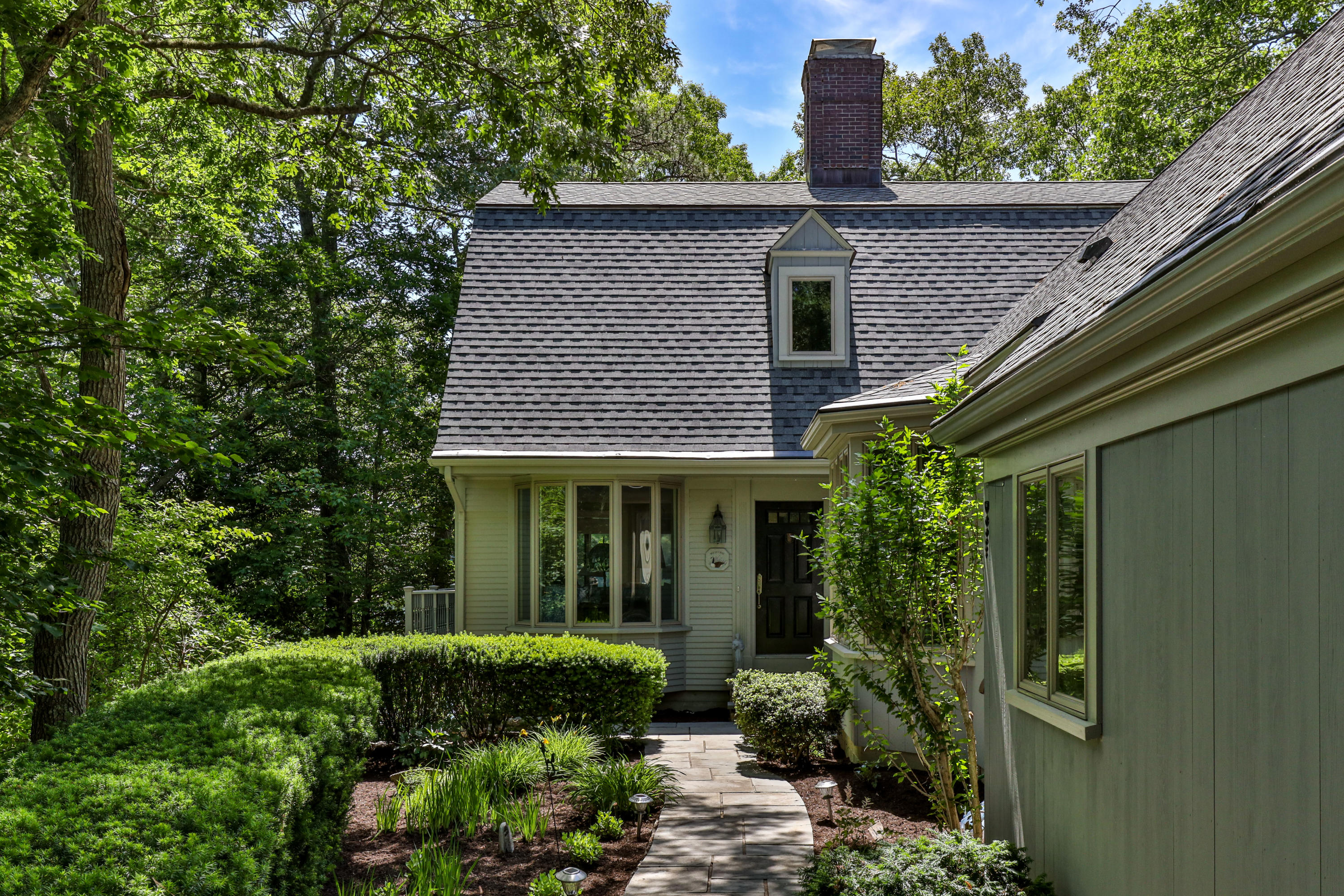 316 Wheeler Road Marstons Mills, MA 02648 - Photo 5 of 50 a view of a house with brick walls and potted plants