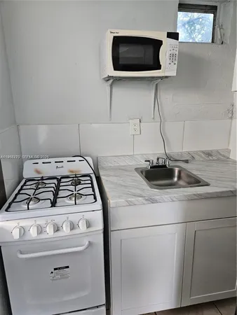 a kitchen with a stove and a microwave