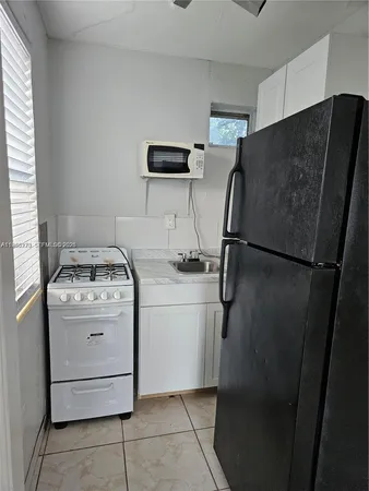 a view of a storage and utility room with washer and dryer