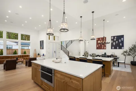 a kitchen with a sink a counter and chairs