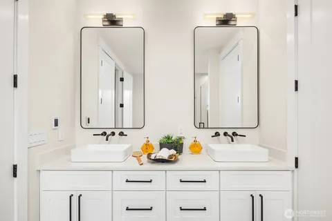 a bathroom with double vanity sink a mirror and vanity