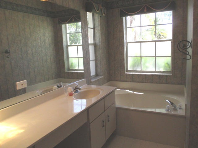 12084 Rockwell Way Boca Raton, FL 33428 - Photo 13 of 25 a bath tub sitting in a bathroom next to a window