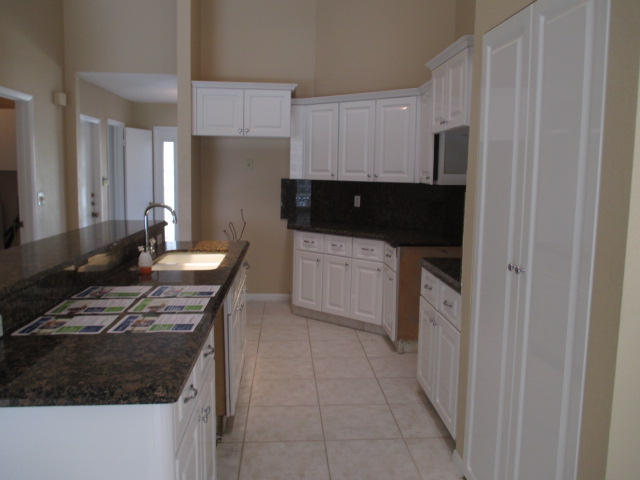 12084 Rockwell Way Boca Raton, FL 33428 - Photo 6 of 25 a kitchen with a sink and a stove top oven