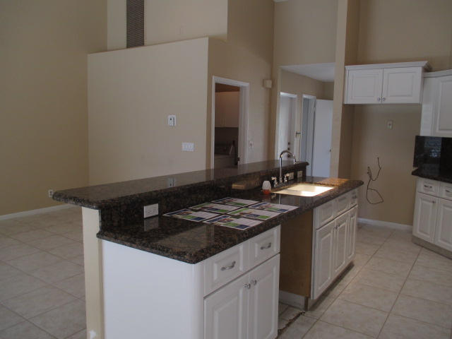12084 Rockwell Way Boca Raton, FL 33428 - Photo 7 of 25 a kitchen with a sink and a refrigerator
