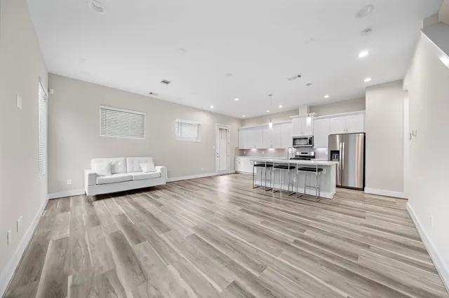 a view of kitchen with furniture and wooden floor