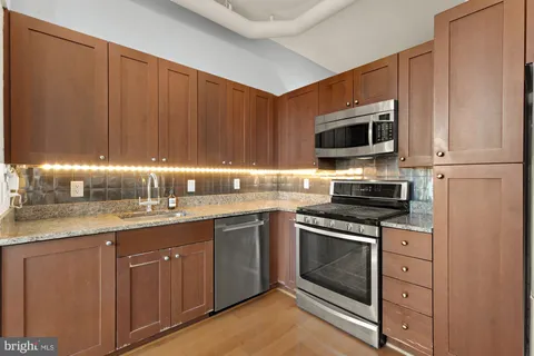 a kitchen with a sink stove and microwave