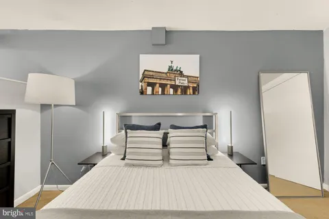 a bedroom with a bed and a night stand