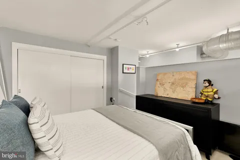 a bedroom with a bed and a wall painting