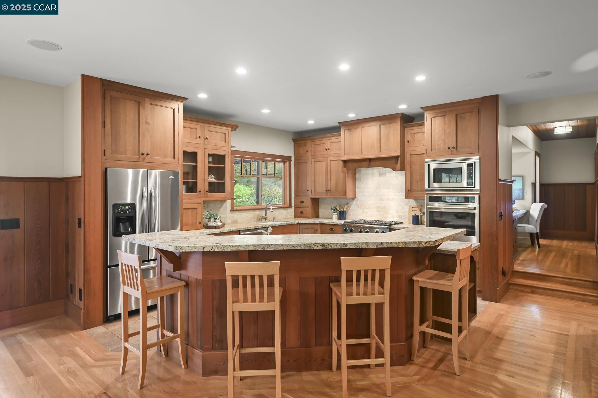 261 Castle Hill Ranch Road Walnut Creek, CA 94595 - Photo 1 of 1 a kitchen with kitchen island granite countertop wooden cabinets and stainless steel appliances