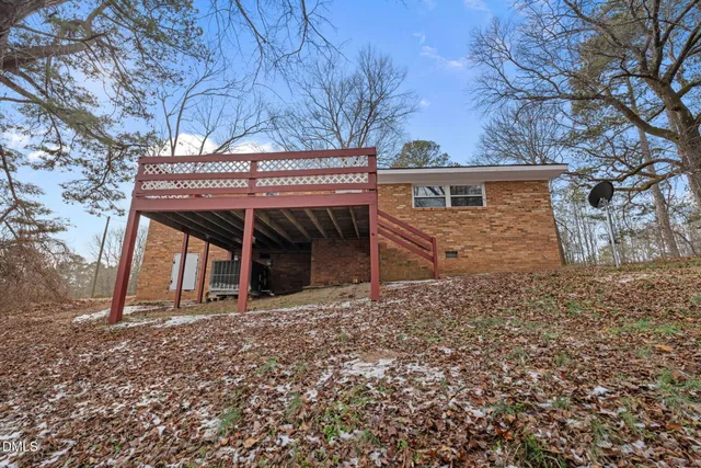 a view of a house with a yard and sitting area