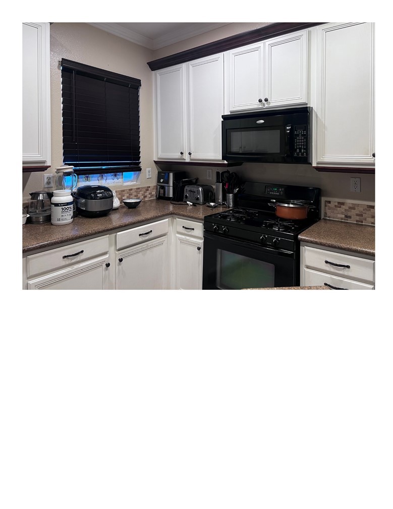 8692 East 9th Street, Unit 29 Rancho Cucamonga, CA 91730 - Photo 8 of 15 a kitchen with stainless steel appliances a stove a microwave and cabinets