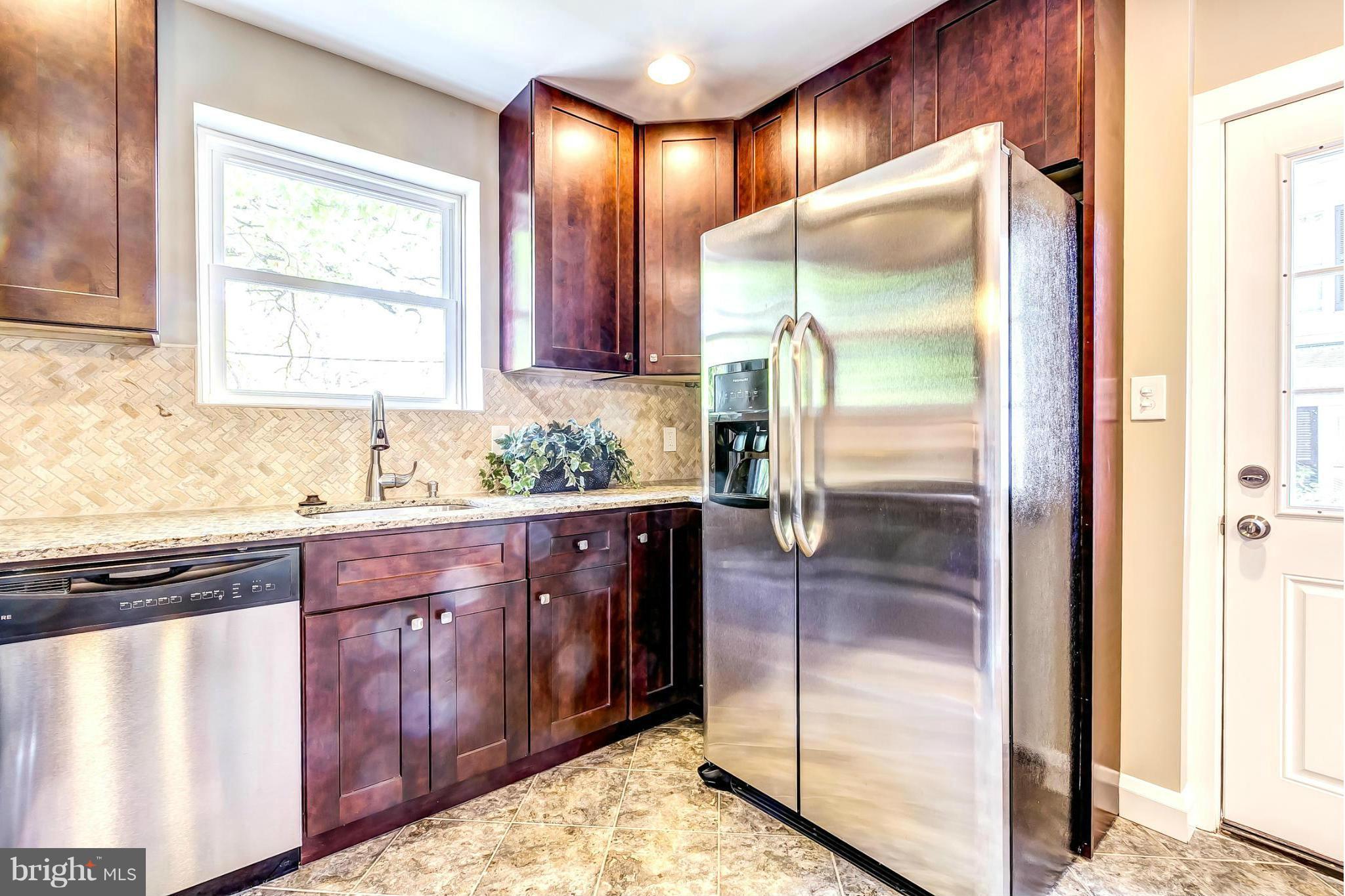 8304 Oakleigh Road Baltimore, MD 21234 - Photo 11 of 30 a kitchen with granite countertop a refrigerator and a sink