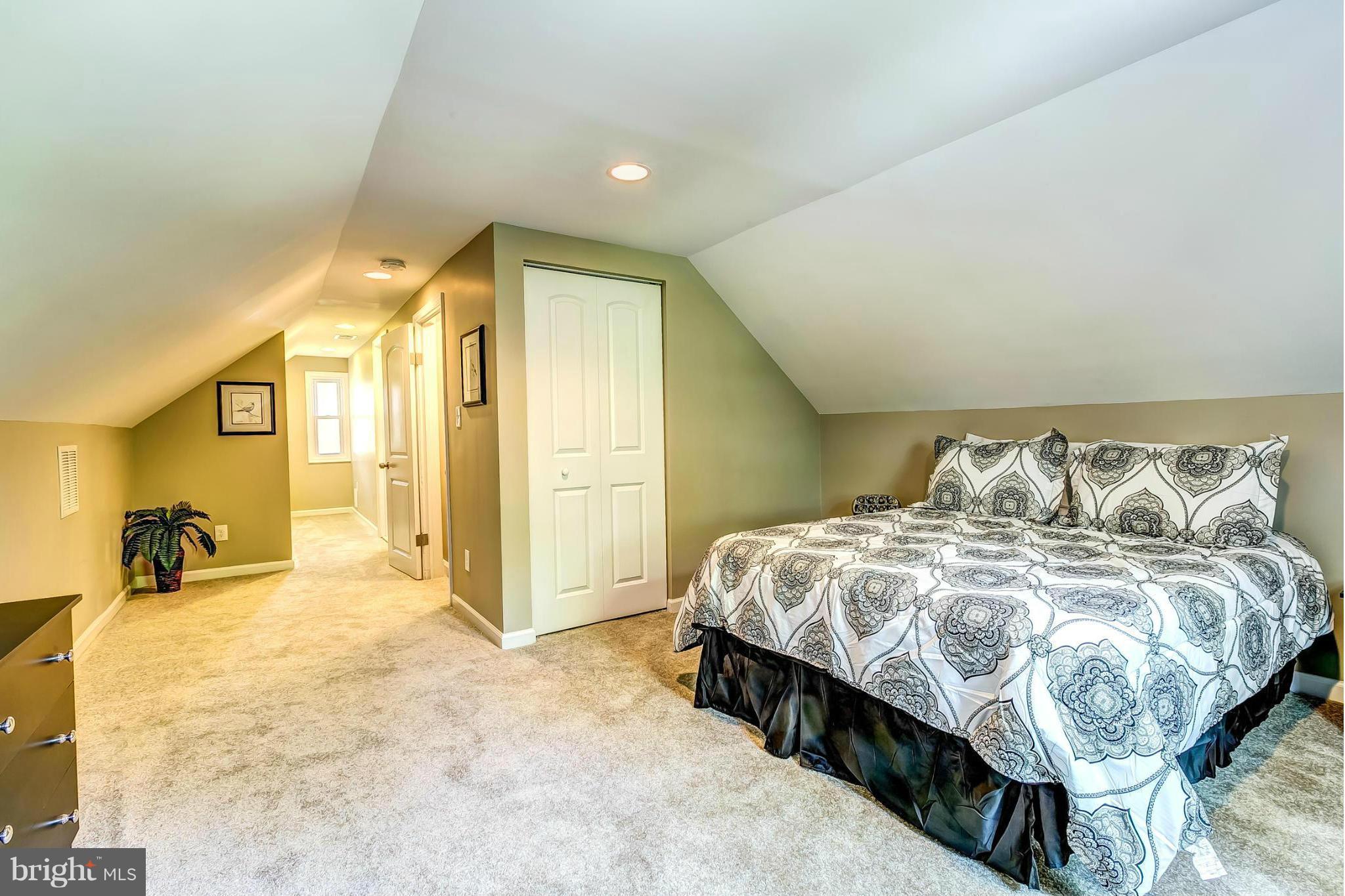 8304 Oakleigh Road Baltimore, MD 21234 - Photo 13 of 30 a spacious bedroom with a bed and a walk in closet