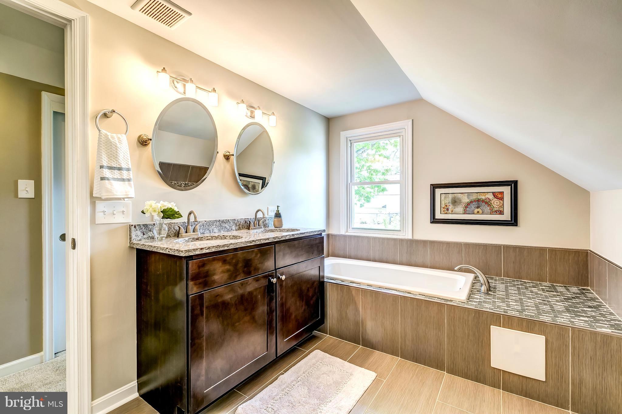 8304 Oakleigh Road Baltimore, MD 21234 - Photo 15 of 30 a bathroom with a bathtub sink and mirror