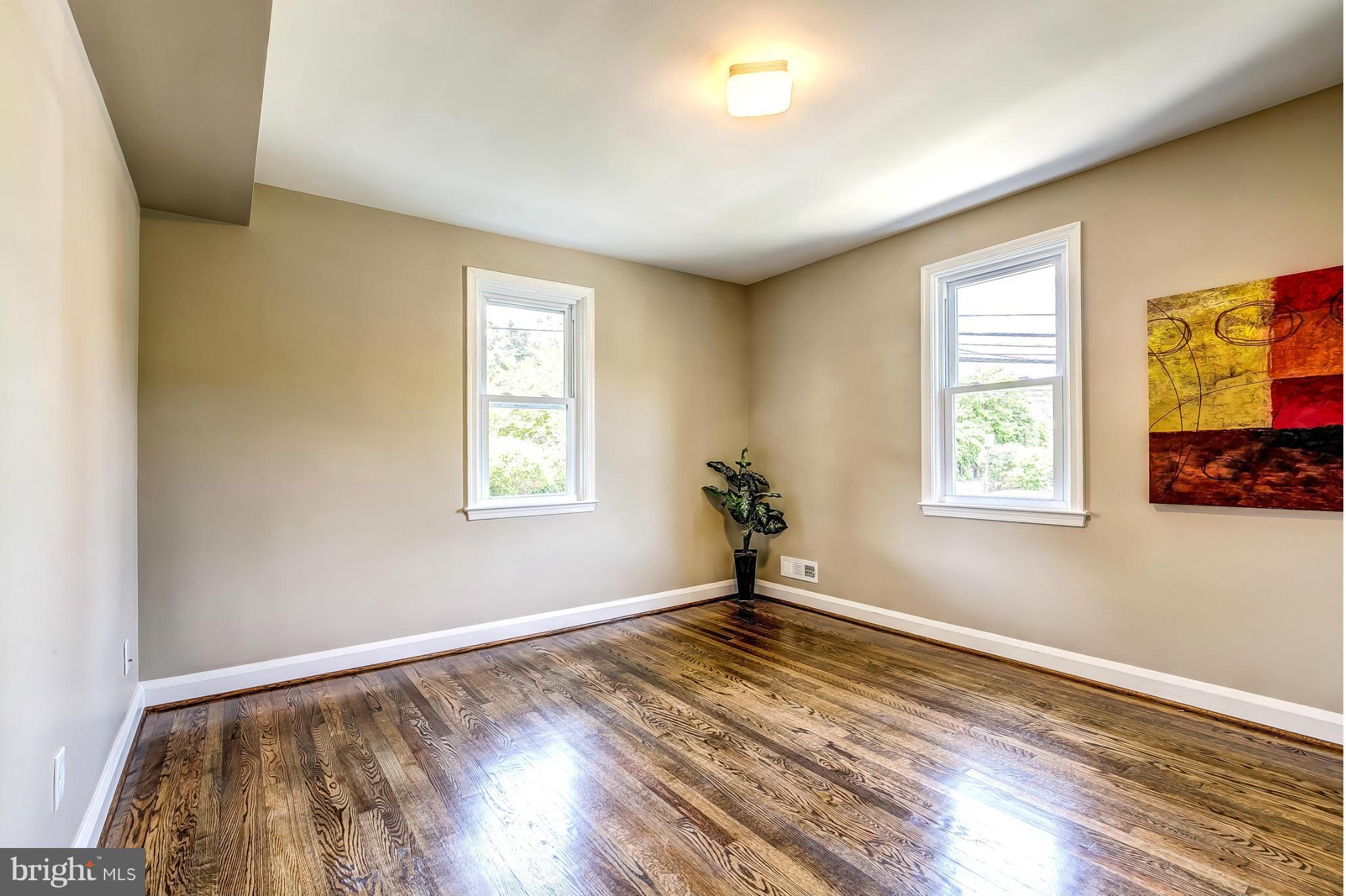 8304 Oakleigh Road Baltimore, MD 21234 - Photo 17 of 30 a view of empty room with wooden floor and fan