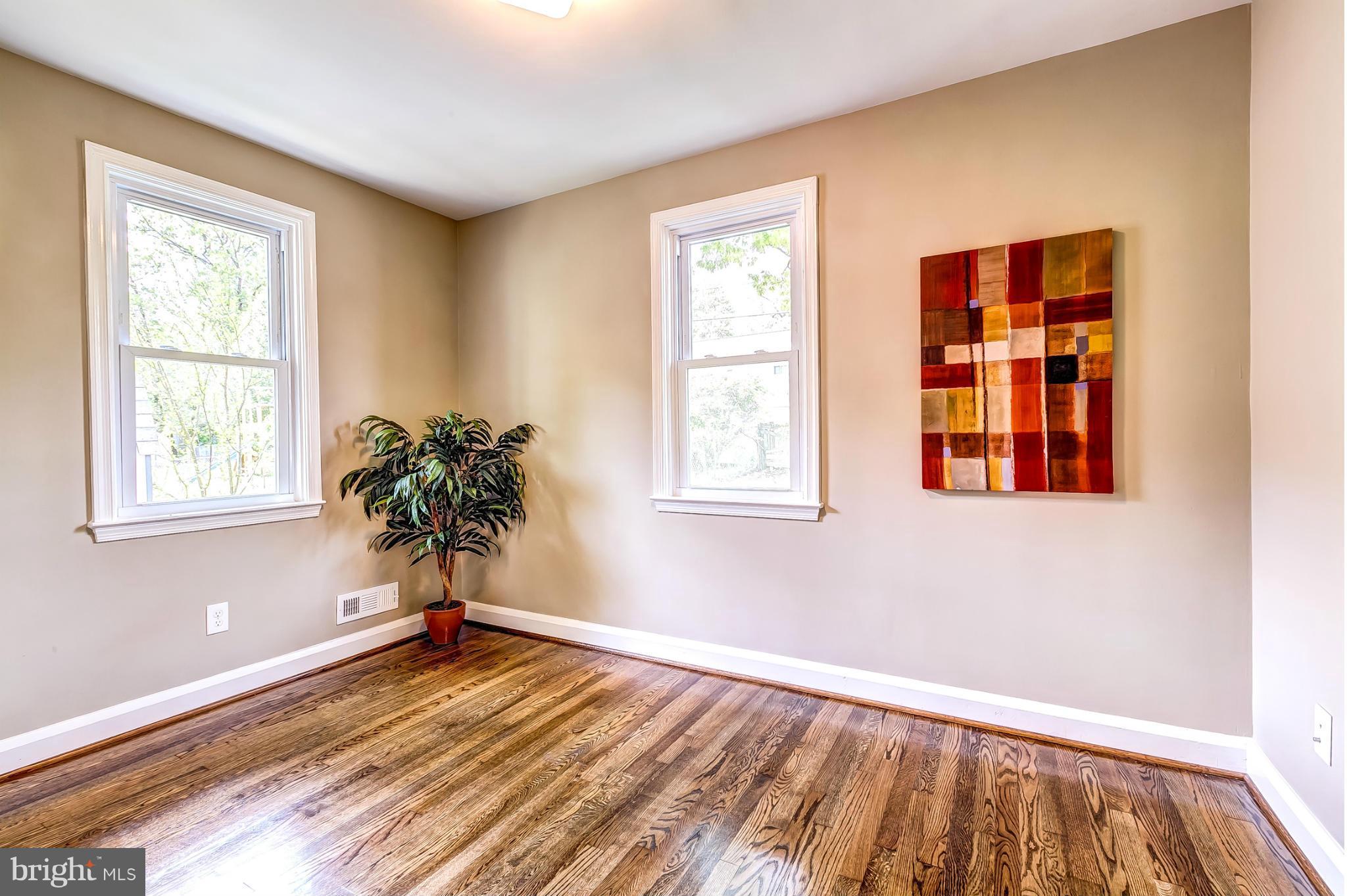 8304 Oakleigh Road Baltimore, MD 21234 - Photo 18 of 30 a view of empty room with wooden floor and fan