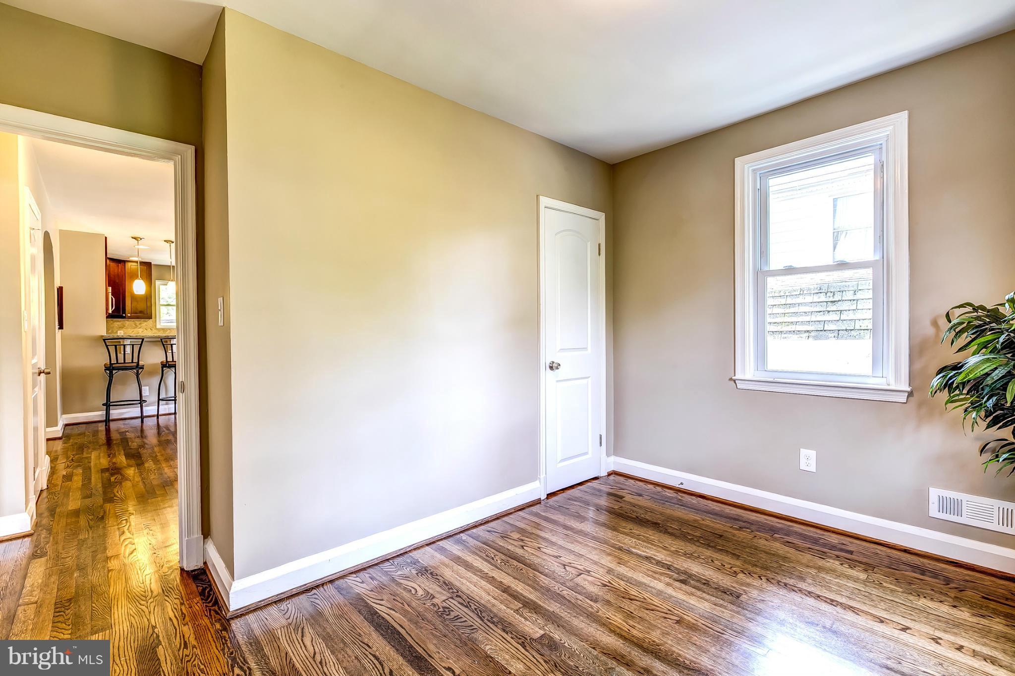 8304 Oakleigh Road Baltimore, MD 21234 - Photo 19 of 30 a view of empty room with wooden floor and fan