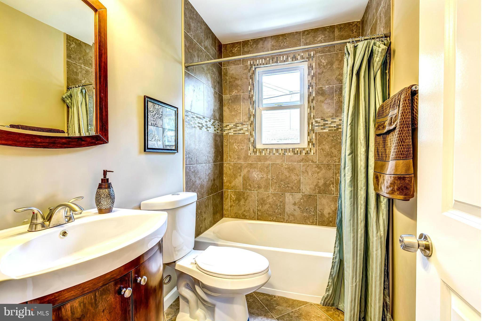 8304 Oakleigh Road Baltimore, MD 21234 - Photo 20 of 30 a bathroom with a sink and a mirror