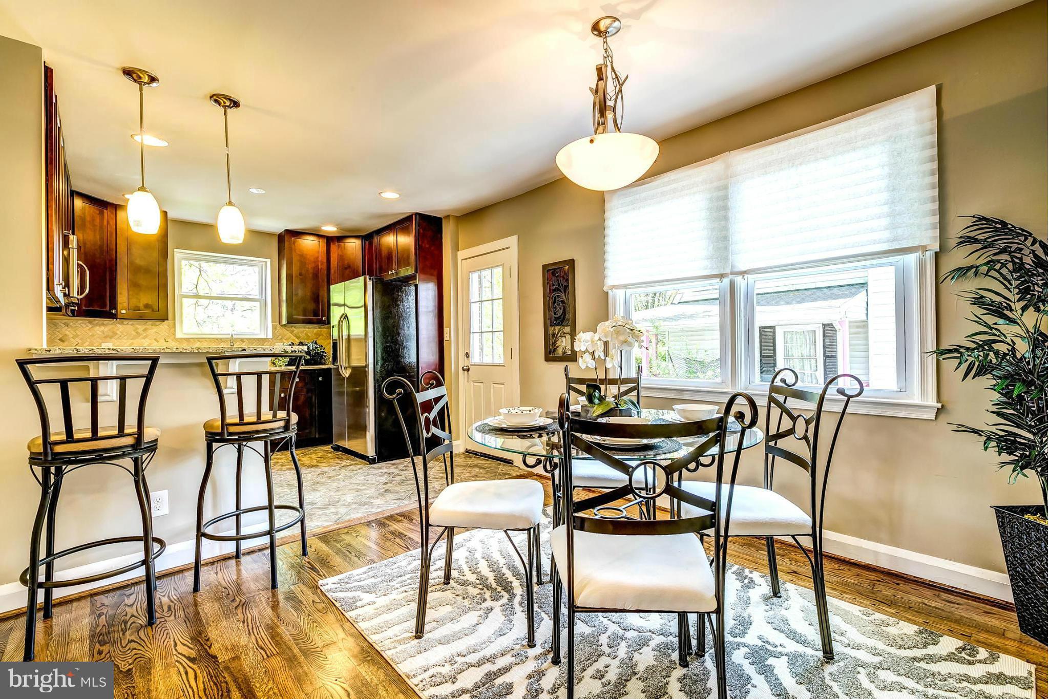 8304 Oakleigh Road Baltimore, MD 21234 - Photo 6 of 30 a view of a dining room with furniture wooden floor and chandelier