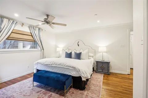 a spacious bedroom with a bed and a chandelier
