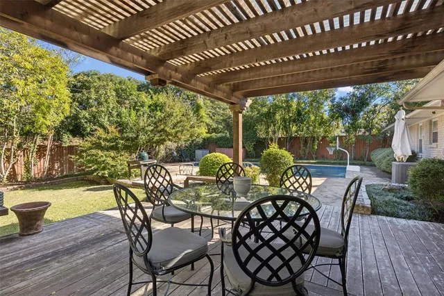 a view of an outdoor dining space with furniture and wooden floor