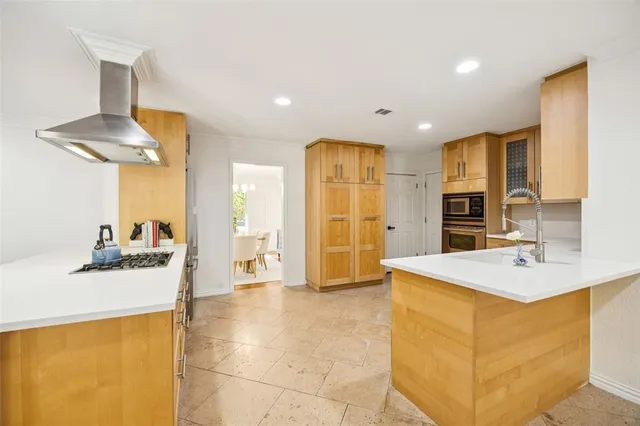 a view of kitchen with stainless steel appliances kitchen island a sink a refrigerator and a stove
