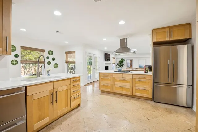 a kitchen with granite countertop a refrigerator and a sink