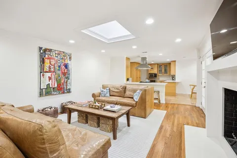 a living room with furniture and kitchen view