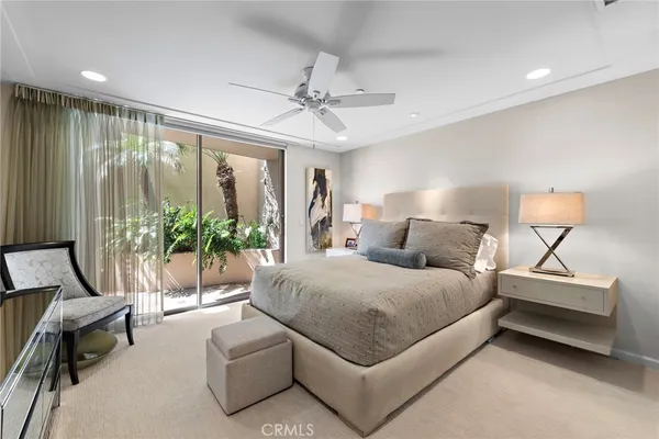 a bedroom with furniture and a flat screen tv