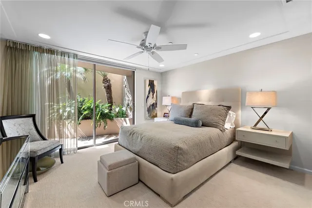 a bedroom with furniture and a flat screen tv