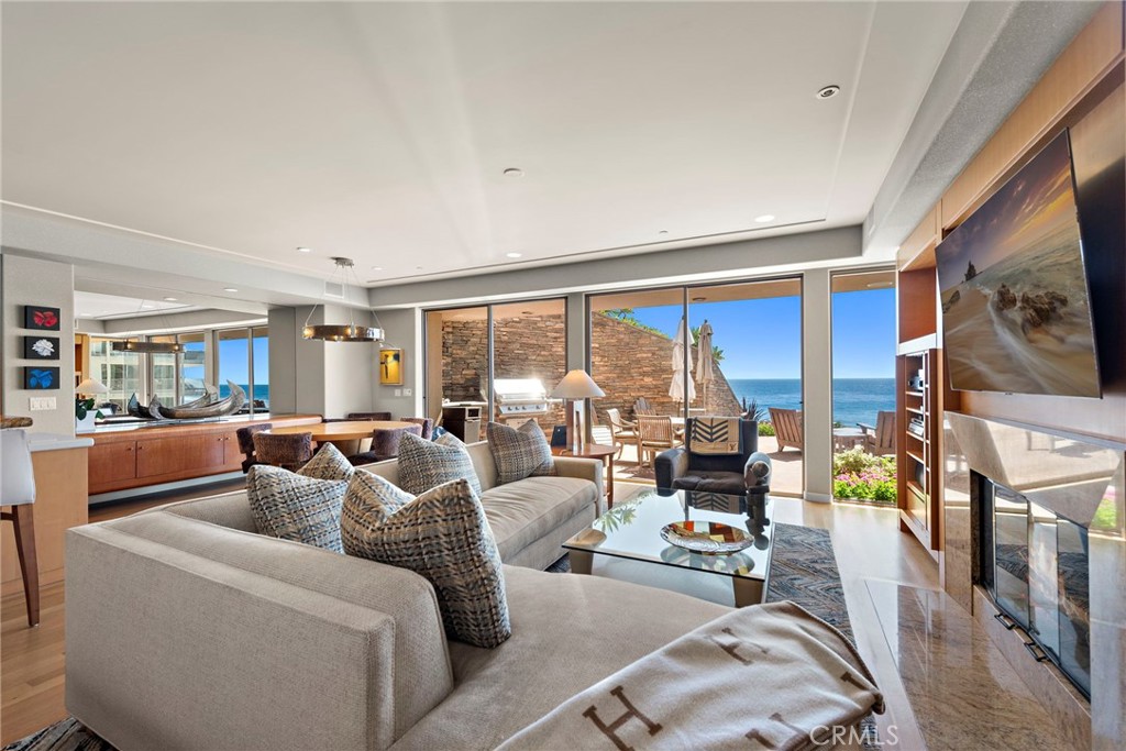 1603-1613 South Coast Highway, Unit F Laguna Beach, CA 92651 - Photo 7 of 34 a living room with furniture fireplace and large windows