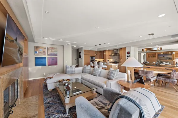 a dining room with stainless steel appliances kitchen island a table and chairs