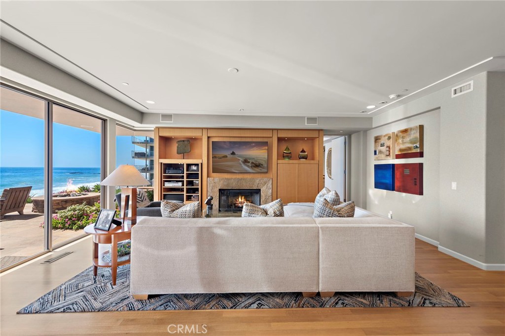 1603-1613 South Coast Highway, Unit F Laguna Beach, CA 92651 - Photo 10 of 34 a living room with fireplace furniture and a large window