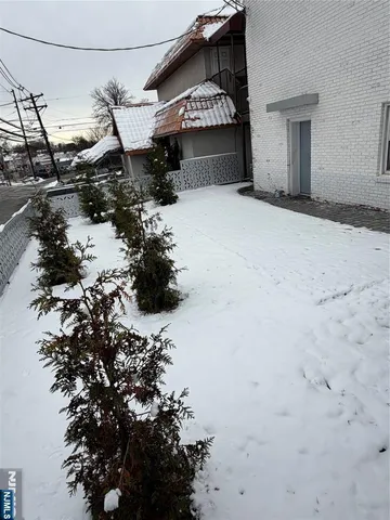 a view of a house with a snow in the yard