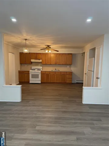 a kitchen with stainless steel appliances wooden cabinets a stove and a refrigerator