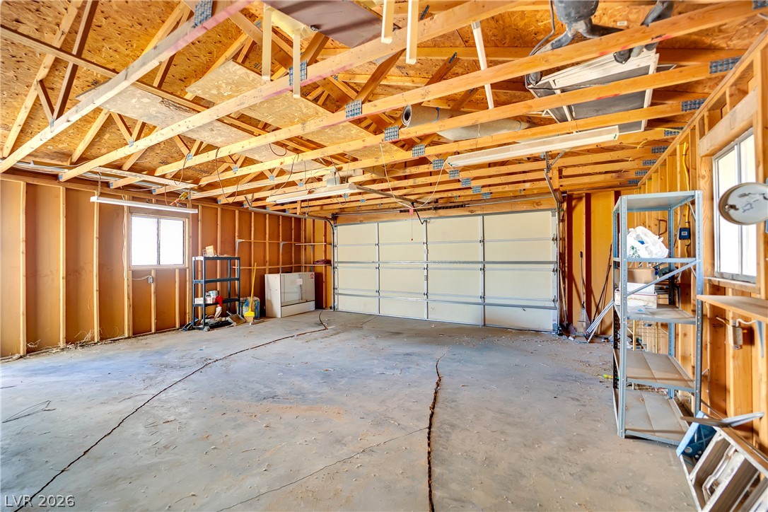 4361 Maple Road Pahrump, NV 89048 - Photo 39 of 46 A spacious, open garage with exposed wooden beams offers abundant utility and storage potential.
