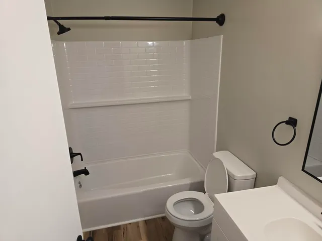 a bathroom with a toilet and a bath tub