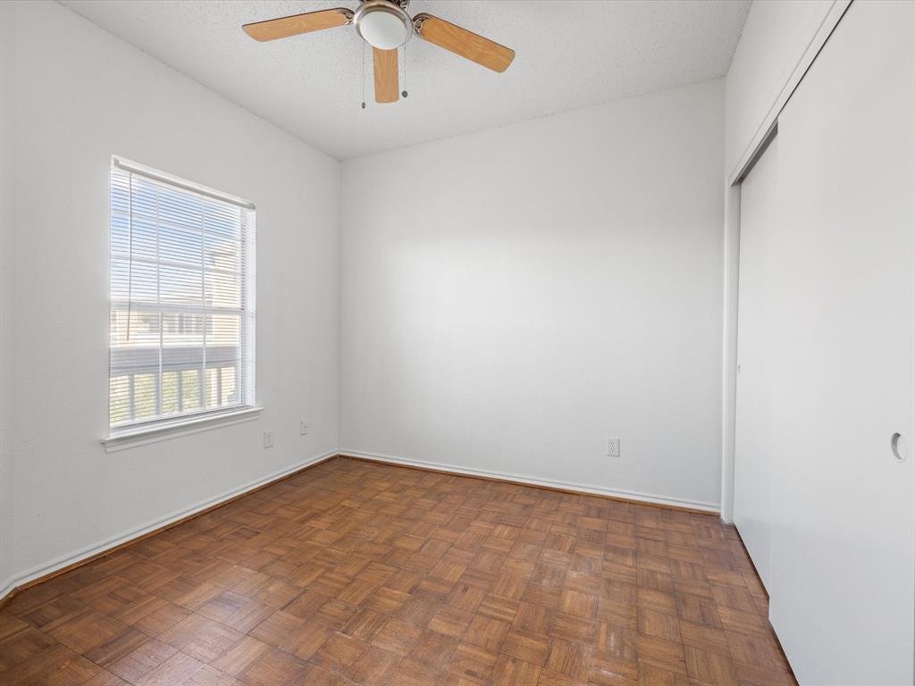 5310 Keller Springs Road, Unit 332 Dallas, TX 75248 - Photo 21 of 39 Unfurnished room with a ceiling fan and a textured ceiling